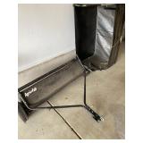 an Agri-Fab tow-behind lawn sweeper. 