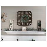 wall arrangement features a tobacco basket adorned with a lambs ear wreath, flanked by "LOVE" and "H
