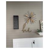 decorative wall sculpture featuring a starburst design with wooden elements and black metal spikes, 