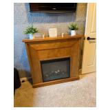 traditional electric fireplace with an oak wood mantel