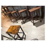 industrial-style backless bar stools with rustic wood seats and dark metal legs.