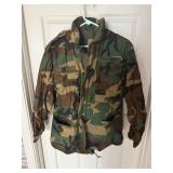 vintage US Army M-65 field jacket in a woodland camouflage pattern