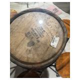 Rustic whiskey barrel bistro table topped with a circular glass surface