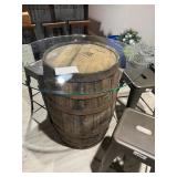 Rustic whiskey barrel bistro table topped with a circular glass surface