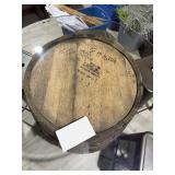 Rustic whiskey barrel bistro table topped with a circular glass surface