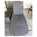 woven wicker outdoor chaise lounge chair.