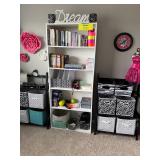 cozy craft room with a white 5-shelf bookcase & matching black folding shelves