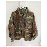 vintage US Army M-65 field jacket in a woodland camouflage pattern