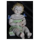 Antique Porcelain Bisque Piano Baby with Doll.  Made in Germany  (12”H x 10,”D x 8”W)