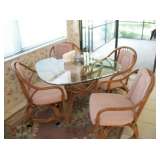 RATTAN TABLE & 4 CASTOR CHAIRS