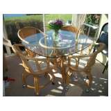 RATTAN TABLE & 4 CASTOR CHAIRS