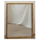 1216	MIRROR IN GILT BAMBOO TURNED FRAME. WIRED TO HANG VERTICALLY OR HORIZONTAL 28 IN X 36 1/2 IN 	7
