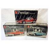 1008	LOT OF 3 AMT ERTL PRESTIGE MODEL CAR KITS, 2 SEALED, 1 OPEN KITS ARE POSSIBLY COMPLETE, NOT GUA