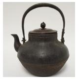 1051	ASIAN CAST IRON TEAPOT W/BASKET WEAVE DESIGN AROUND EXTERIOR & BRONZE LID, 8 IN HIGH	100	200	50