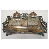 1104	VICTORIAN SILVER PLATED INKWELL SET W/ TWO CUT GLASS INKWELLS, SOME CHIPPING ON GLASS. 12 IN W 