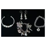 1258	STERLING SILVER CHARM BRACELET 9 OF 15 CHARMS MARKED STERLING, STERLING CHARM BRACELET WITH CHA