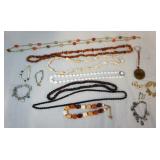 1151	LOT OF COSTUME JEWELRY INCLUDING SEVEN NECKLACES, FIVE BRACELETS; TWO OF WHICH ARE CHARM BRACEL