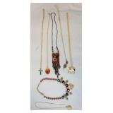 1184	LOT OF SEVEN NECKLACES. LOT INCLUDES ONE W/ AN ELEPHANT PENDANT WHICH DOUBLES AS A BROOCH PIN, 