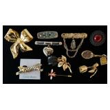 1196	LOT OF NINE BROOCH PINS & A HAT PIN. 