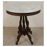 1098	OVAL WALNUT MARBLE TOP TABLE 22 IN X 16 1/2 IN 30 1/4 IN H 