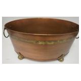 1104	LARGE COPPER OVAL POT WITH BRASS TRIM, HAS A DECORATIVE BRASS BAND, FEET AND RING HANDLES, 24 1