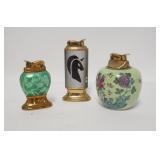1221	LOT OF 3 LIGHTERS IN DECORATIVE CASES. TALLEST IS 4 3/4 IN H 