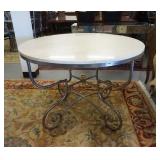 1144	ROUND STONE TOP TABLE ON SCROLLED IRON BASE W/BRASS FINIAL IN CENTER, 41 IN X 29 IN HIGH