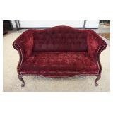 1147	RED VELOUR TUFTED BACK LOVE SEAT W/BRASS TICKING ACCENTS, 57 IN X 28 IN X 32 IN HIGH