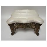 1172	SMALL UPHOLSTERED FOOT STOOL METAL BASE. HAS SOME STAINING 14 IN X 8 1/2 IN 
