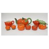 1229	GROUP OF TOMATO FORM CHINA. ONE OF THE CREAMERS IS ROYAL BAYREUTH. TEAPOT IS 5 IN H 