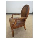 1011	CARVED MEDALLION LEATHER BACK ARM CHAIR. 27 IN W, 40 IN H 