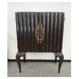 1022	2 DOOR LIGHT BAR ON HIGH CABRIOLE LEGS, HAS GLASS SHELVES, INTERIOR OF DOORS ARE DECORATED, GOL