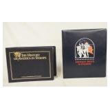 1034	LOT OF TWO COMMEMORATIVE STAMP ALBUMS; THE HISTORY OF AMERICA IN STAMPS & AMERICAS MARCH TO FRE