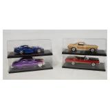 1261	LOT OF FOUR DIE CAST 1:18 SCALE MODEL CARS IN DISPLAY CASES.
