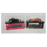 1263	LOT OF TWO DIE CAST 1:18 MODEL CARS IN DISPLAY CASES W/ ORIGINAL BOXES. LOT INCLUDES PLYMOUTH P