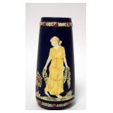 1100	UNSIGNED WELLER ART POTTERY VASE FEATURING A WOMEN HOLDING A GARLAND OF FLOWERS. 7 3/4 IN H 