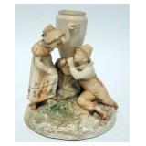 1103	ROYAL WORCESTER FIGURAL BUD VASE OF BOY & GIRL. BOY HAS A TRUMPET. 6 3/4 IN H 