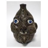 1154	GRACEWELL HEWELL GROTESQUE FACE JUG, UGLY FACE FOLK ART JUG, WITH A TOBACCO SPIT GLAZE. 7 1/2  