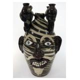 1159	ALBERT HODGE GROTESQUE FACE JUG,VALE N.C.,DEVIL WITH SANKE SWIRL CANDELABRA, 15 1/2 IN HIGH, SI