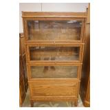 1177	SOLID OAK 4 SECTION BARRISTER BOOKCASE HAS ONE BLIND DOOR. 34 IN W, 11 IN DEEP, 63 IN H 