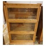1178	OAK 3 SECTION BARRISTER BOOKCASE HAS PANELED SIDES & BEVELED GLASS DOORS. 36 IN W, 12 IN DEEP, 