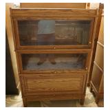 1180	OAK 3 SECTION BARRISTER BOOKCASE HAS ONE BLIND DOOR. 34 IN W, 11 IN DEEP, 51 IN H 