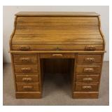 1183	EAGLE IND INC. OAK S ROLLTOP DESK. SMALL SIZED PANELED SIDES & HAS KEYS. ONE PIECE. 47 1/2 IN W