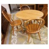 1184	S BENT BROTHER ROUND OAK TABLE & FOUR CHAIRS. 42 IN HAS TWO 11 3/4 IN  LEAVES. CHAIRS HAVE HOOP