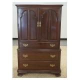 1206	ETHAN ALLEN BLACK CHERRY WARDROBE HAS TWO PANELED DOORS OVER THREE DRAWERS THE INTERIOR HAS THR