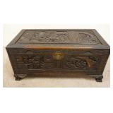 1218	ANTIQUE ASIAN CAMPHOR WOOD CHEST W/ ORNATE SCENIC CARVING, & DOVETAILED FIGURAL FEET W/ TRAY. 1