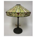 1002	ANTIQUE STAINED GLASS TABLE LAMP, HAS RAISED RED JEWELS ON THE BORDER. 23 IN H APP. 8 IN DIAMET