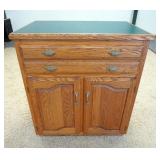1052	2 DOOR 2 DRAWER CHEST HAS A GREEN FORMICA TOP. 39 IN W 45 IN H 25 IN DEEP