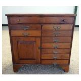 1055	COUNTRY STORE CABINET W/ NINE DRAWERS & ONE DOOR. HAS A FALL FRONT TOP SLOT. 40 IN W 39 IN H 15