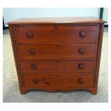 1057	4 DRAWER ANTIQUE CHEST HAS BOBBIN TURNED HALF COLUMNS, & SCALLOPED SKIRT. 38 IN W, 35 IN H 17 I